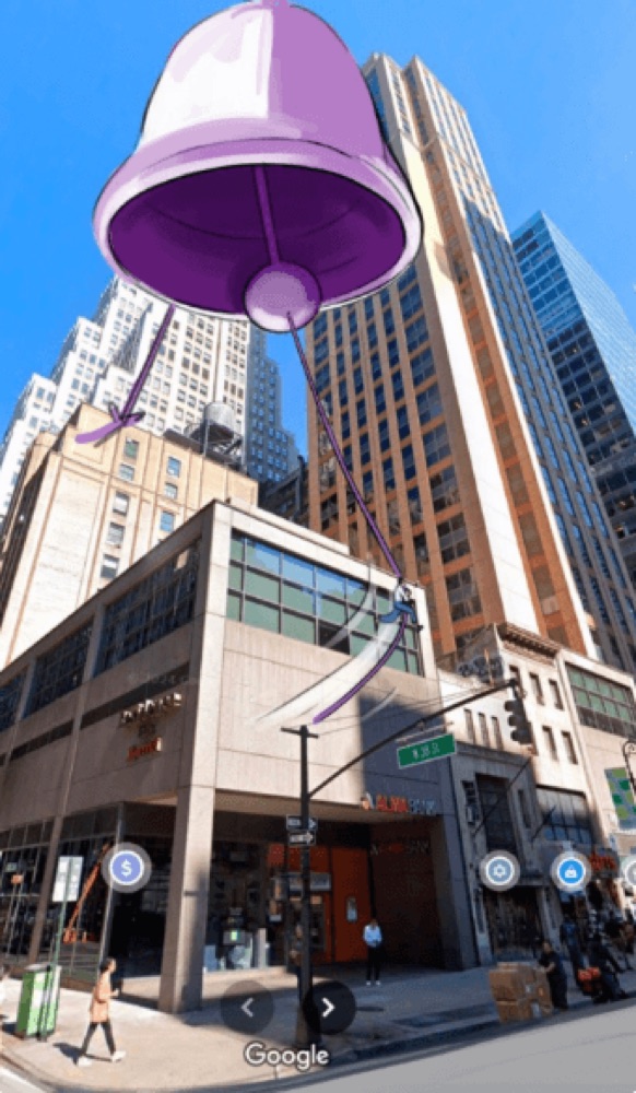 A conceptual sketch shows a giant purple bell hanging over a busy city street corner